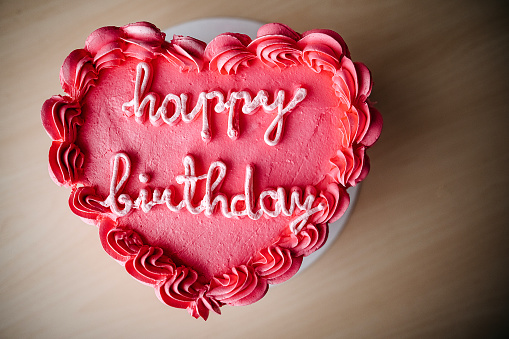 Red heart-shaped birthday cake