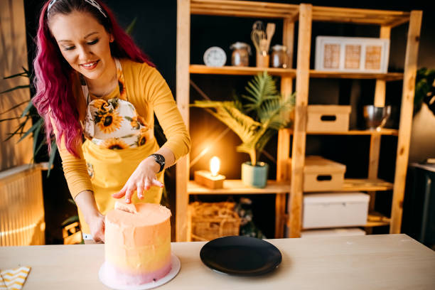 istock Woman cuts the cake 1355826293