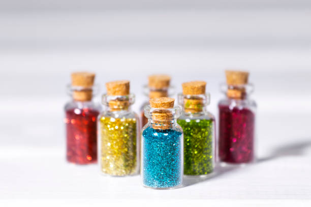 istock Small Glass jars with Colorful glitters for nail art and makeup on white background, Copyspace 1355826381