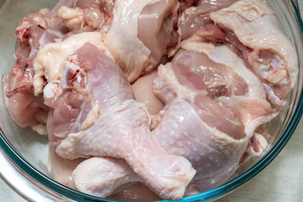 istock Fresh chicken cut into pieces in a glass bowl. 1355827087