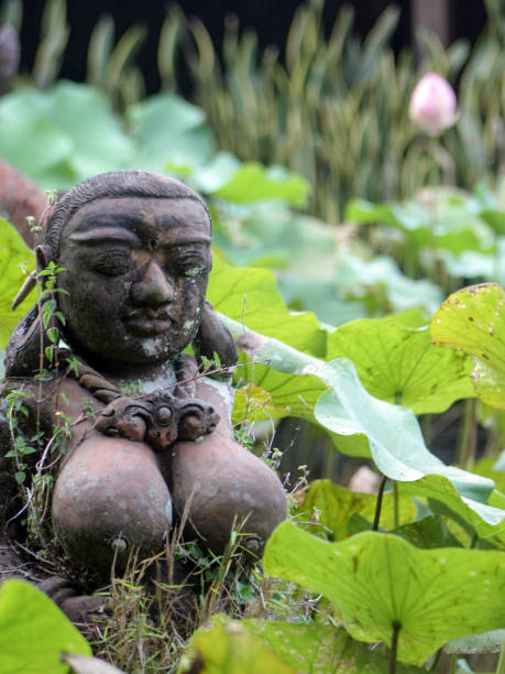 istock lotus flower and statue. 1355830989