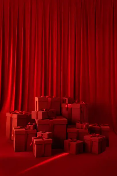 Photo of Large gift boxes with a bow on a red background