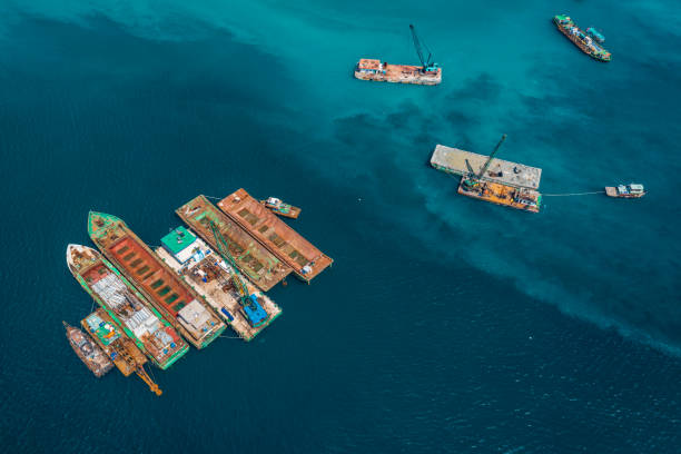 istock Lighters and crane vessels on Ca Na beach 1355833209