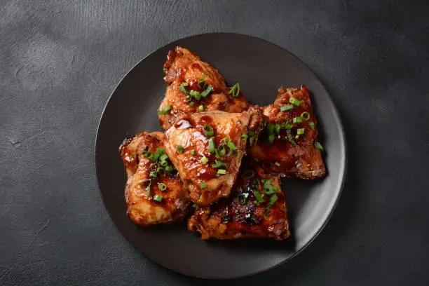 Chicken thighs marinated and cooked in adobo sauce. National filipino dish.