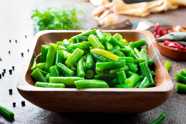 istock Sauteed green beans with pine nuts in a baking dish, healthy side dish. 1355835526