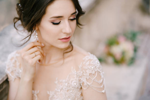 istock Bride sits near a stone balustrade. Portrait 1355835611