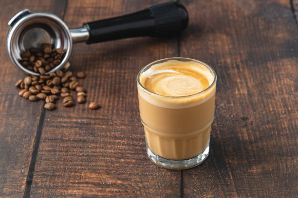 istock Cortado coffee with coffee beans next to it. Traditional coffee in Spain. 1355835898