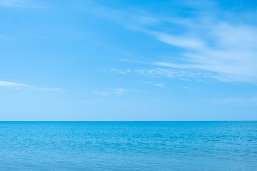 Ocean beauty. Nature scenery. Peaceful harmony. Azure glaze of calm water surface and blue sky in sunny daylight.