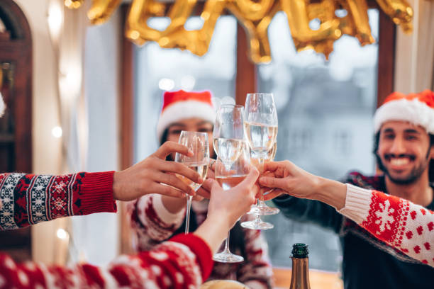 istock friends toasting at christmas dinner 1355837684