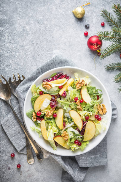 istock Fresh Waldorf salad with lettuce, green apples, walnuts and celery on wooden table. Top view.Copy space 1355838974