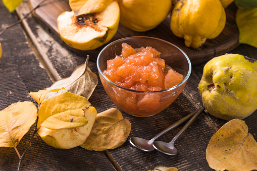 Ripe whole quince and sweet jam from it. Fresh fruit, an essential ingredient for a healthy diet