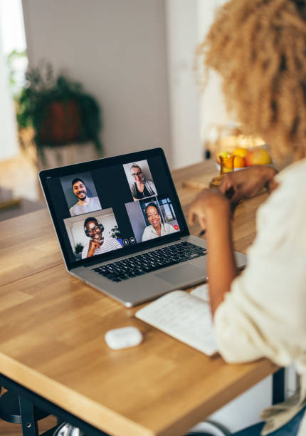 istock Anonymous Woman Having a Conference Call on her Laptop 1355840286