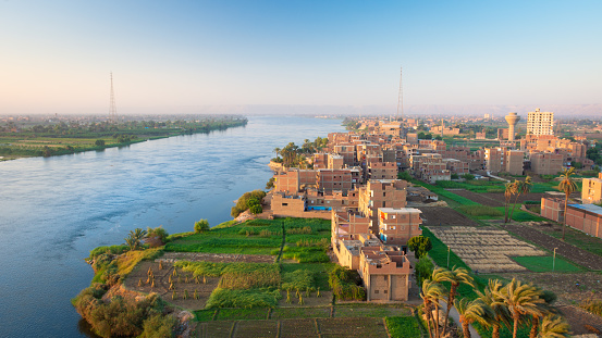 Crowded village in a developing country view. The sunset scene from Sohag city in south Egypt showing Naidah village which overlooks the Nile river