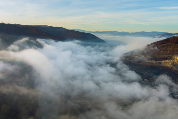 istock Misty foggy mountain landscape with autumn forest 1355840564