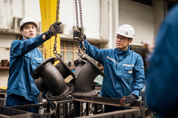 istock Blue collar workers working in steel factory 1355840692