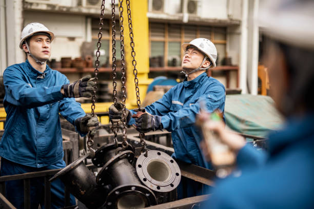 istock Blue collar workers working in steel factory 1355840693