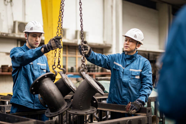 istock Blue collar workers working in steel factory 1355840695