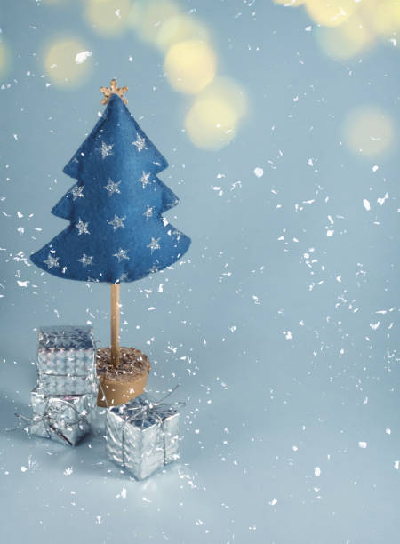 istock Christmas tree made of blue felt and silver gift boxes 1355840786