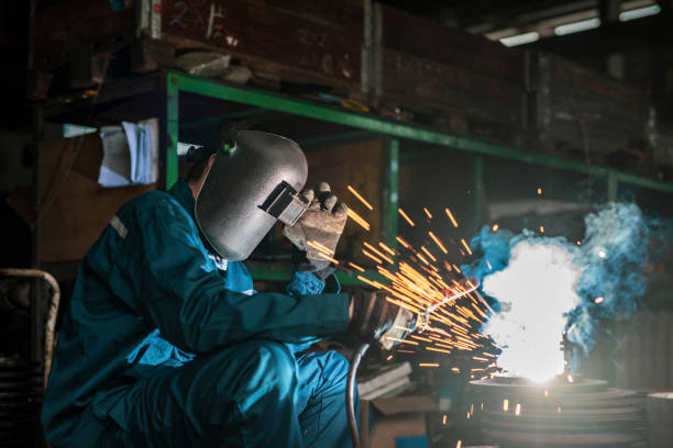Welder welding in steel factory stock photo