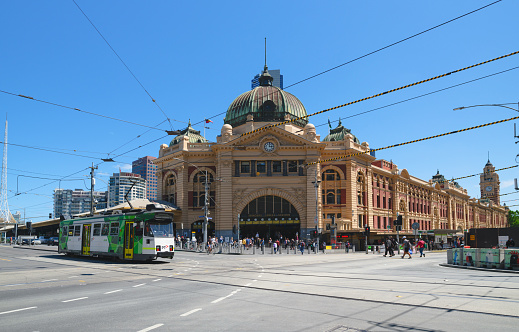 Melbourne, Australia - November 27: Pedestrians and cylers at the iconic Flinders Street Station in Melbourne, Australia