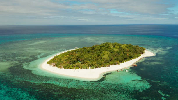 istock Tropical island with sandy beach. Mantigue Island, Philippines 1355841627