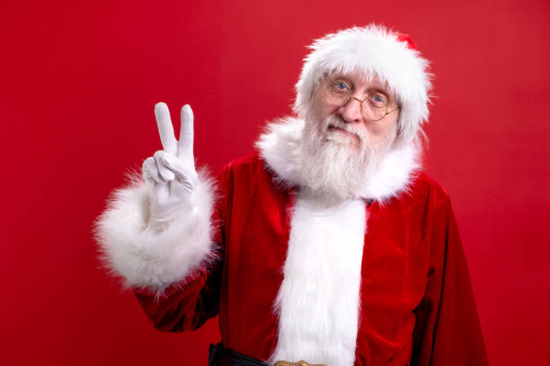 istock Portrait real authentic surprised shocked Santa Claus Santa isolated on red studio background. Fulfillment of desires 1355842807