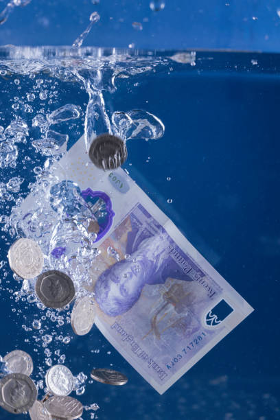 Money laundering concept Money down the drain concept. twenty pound note stock pictures, royalty-free photos & images