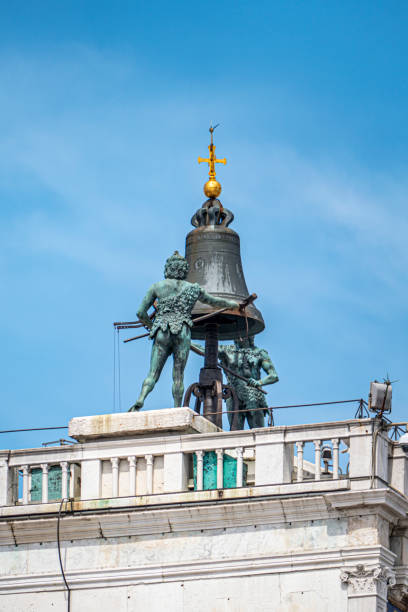 istock moors ringing the bell of Venice bell tower with a hammer 1355845116