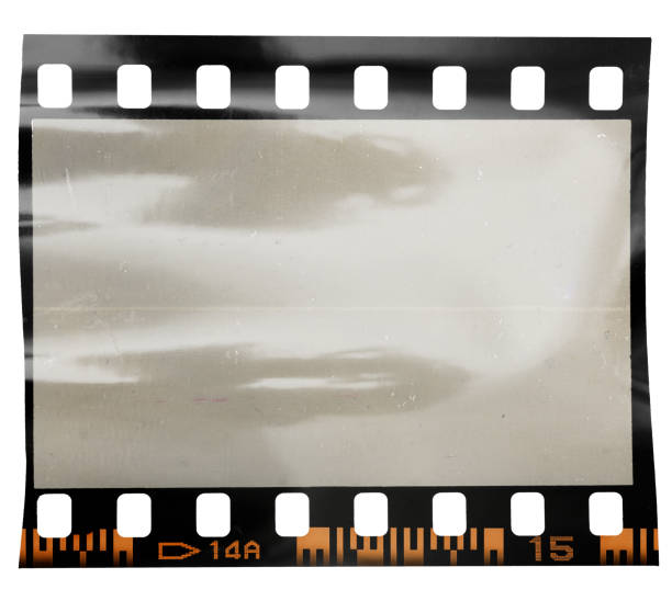 istock single 35mm dia filmstrip on white background with nice light reflection and dust. 1355845152