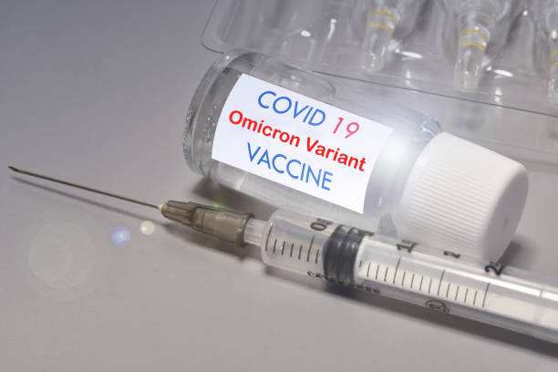 Covid-19 Omicron variant strain vaccine. Syringe and vaccine. Treatment for coronavirus covid-19. stock photo