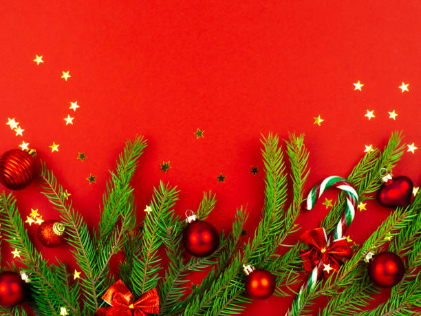 istock Fir branches with red balls on a red background. Festive Christmas background . 1355848949