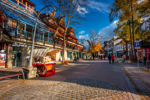 People on the main Krupowki street in Zakopane at autumn Zakopane, Poland - November 4, 2021: People on the main Krupowki street in Zakopane at autumn. Krupowki street is the main shopping and restaurant area in Zakopane, Poland. tatra tourists stock pictures, royalty-free photos & images