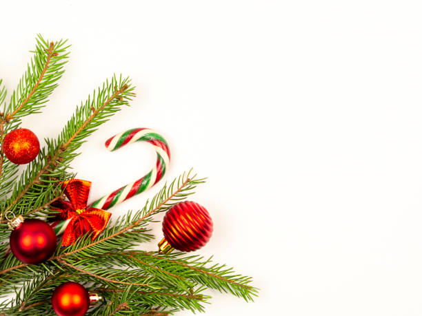 istock Spruce branches with red balls on a white background. Festive Christmas background. 1355849116