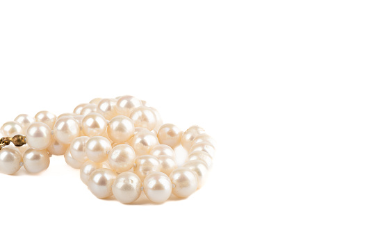 Pearl necklace on a white background with place for text. Copy space.