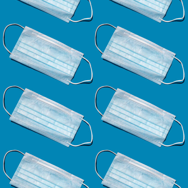 istock Seamless pattern of disposable face masks. 1355850336