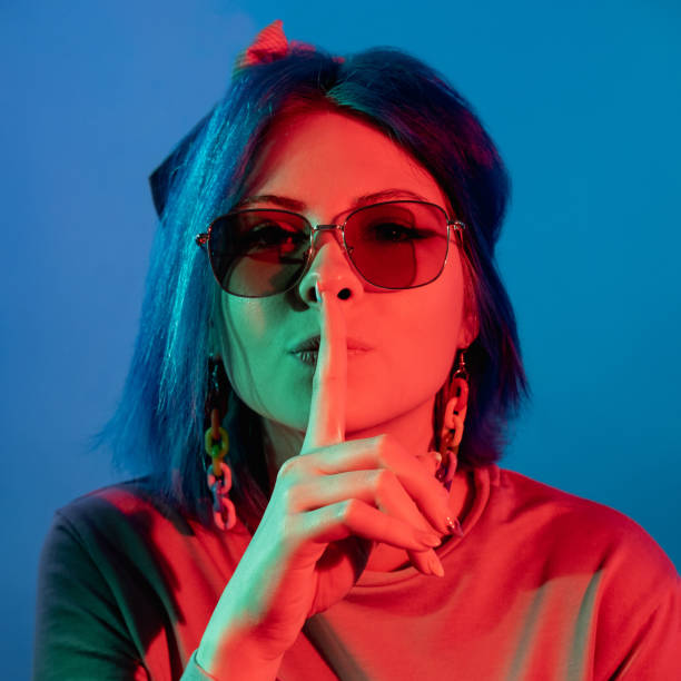 istock silence gesture keep quiet neon light woman shh 1355854532