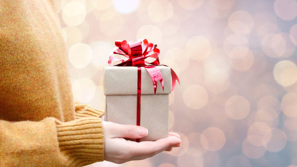 istock gift in the hands of a girl 1355854800