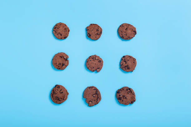 istock Chocolate and white cookies on a blue background. Top view, flat lay. 1355857924