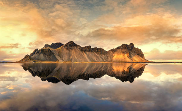 istock Sunset at Vestrahorn with mirror reflection. Iceland in autumn. 1355860104