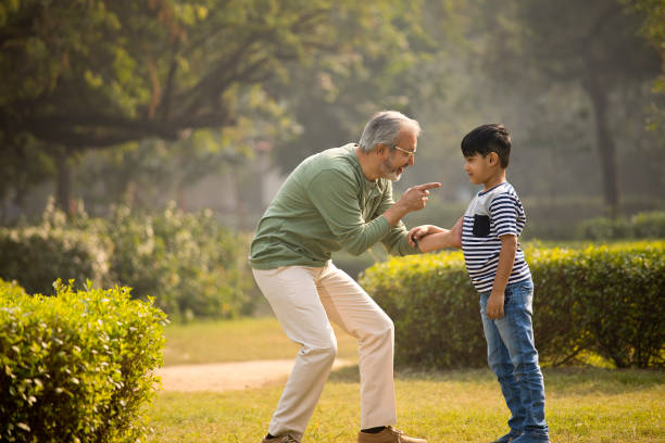 istock Senior man with his grandson at park 1355860973