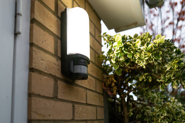 Exterior PIR LED security light seen glowing following body motion detection via its Infra Red sensor. Exterior PIR LED security light seen glowing following body motion detection via its Infra Red sensor. Located by a garage door sensor photos stock pictures, royalty-free photos & images