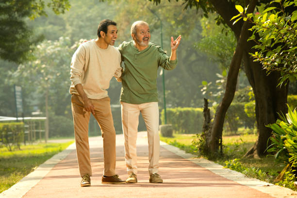 istock Happy senior man admiring view with son at park 1355864115