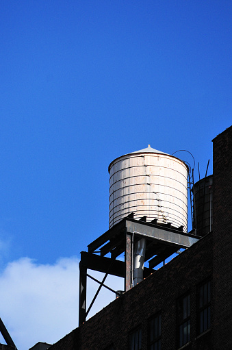Manhattan, New York, USA: rooftop water tank on a steel platform. Tanks were placed on rooftops when the local water pressure was too weak to raise water to upper levels. When construction started to grow taller, the city required that buildings with six or more stories be equipped with a rooftop tank with a pump.