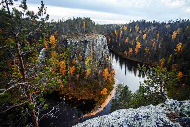 istock The Ristikallio is a harsh rock formation in Avento river that streams next to this rock. Oulanka National Park 1355865968