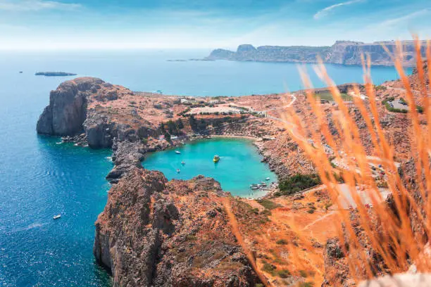 Panoramic view from a height of the Mediterranean coast and St. Paul's Bay in the city of Lindos from the Acropolis in beautiful sunny weather, Rhodes island, Greece