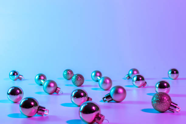 istock Christmas balls pattern neon background. Xmas bauble on abstract holiday winter gradient backdrop. Happy new year copy space. 1355871333