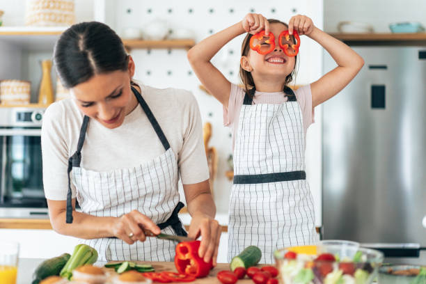 istock Mother and daughter in the kitchen 1355872386