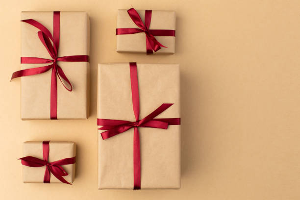 istock Box wrapped in craft paper on craft paper background 1355878436