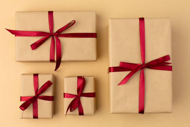 istock Box wrapped in craft paper on craft paper background 1355878442