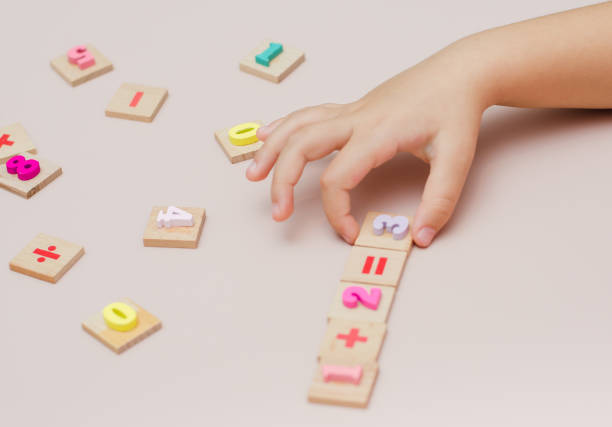 istock Five year old child learn learns arithmetic using a set of wooden numbers 1355878750